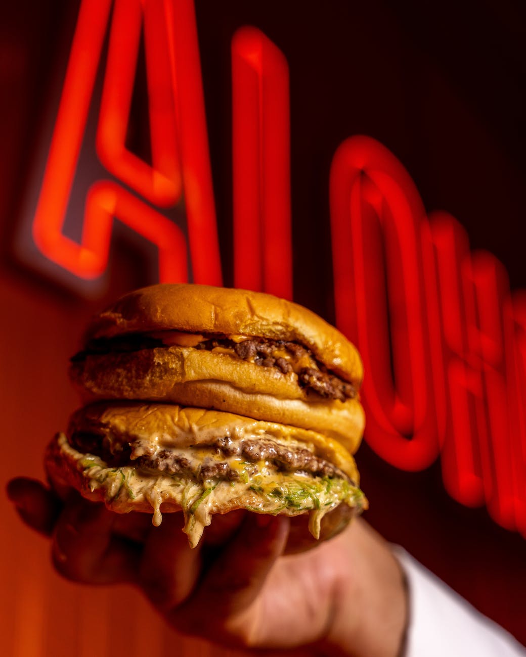 "Juicy Cheeseburger with Lettuce, Tomato, and Pickles on a Sesame Seed Bun"