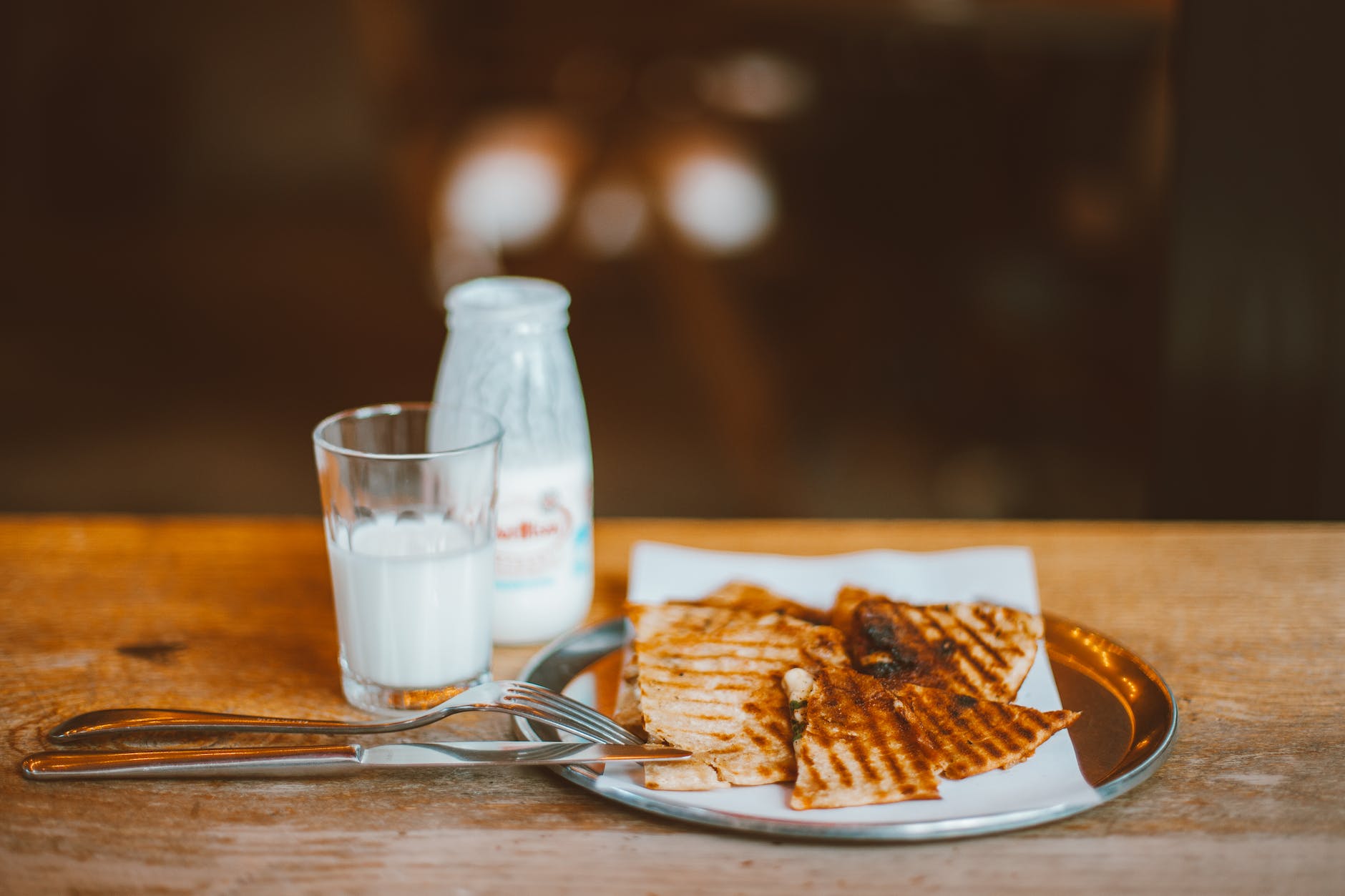 A bottle of milk with a diverse range of nutritional benefits including calcium for strong bones, vitamins for overall health, protein for muscle growth, immune system support, hydration, and more.